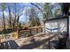 Spacious back deck with railing, featuring outdoor seating and a hammock, ideal for enjoying the natural surroundings at 530 Bolton Nw Rd, Atlanta, GA 30331