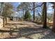 Large backyard with a wooden fence, mature trees providing shade, and plenty of open space for recreation at 530 Bolton Nw Rd, Atlanta, GA 30331