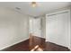 Cozy bedroom with hardwood floors, neutral walls, ample closet space, and a starburst light fixture at 530 Bolton Nw Rd, Atlanta, GA 30331