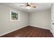 Bedroom featuring hardwood floors, ceiling fan and a window bringing in natural light at 530 Bolton Nw Rd, Atlanta, GA 30331