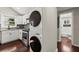 Modern kitchen with white cabinets, stainless steel appliances, and dark hardwood floors, plus convenient in-unit laundry at 530 Bolton Nw Rd, Atlanta, GA 30331