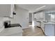 Bright kitchen with white cabinetry, quartz countertops, stainless steel appliances and view to dining room at 7051 Greenridge Dr, Loganville, GA 30052