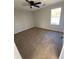 Cozy bedroom with soft carpeting, a ceiling fan, and a window offering natural light at 1126 Mainstreet Valley Dr, Stone Mountain, GA 30088