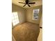 Inviting bedroom featuring soft carpet, a ceiling fan, and a window providing plenty of natural light at 1126 Mainstreet Valley Dr, Stone Mountain, GA 30088