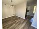 Dining room with wood floors and modern lighting at 1126 Mainstreet Valley Dr, Stone Mountain, GA 30088