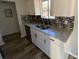 Kitchen sink with granite countertop and mosaic tile backsplash at 1126 Mainstreet Valley Dr, Stone Mountain, GA 30088