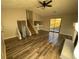 Spacious living room with wood flooring, a stone fireplace, and access to stairs and a large window at 1126 Mainstreet Valley Dr, Stone Mountain, GA 30088