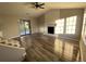 Bright living room featuring wood flooring, a cozy fireplace, and sliding glass doors to the backyard at 1126 Mainstreet Valley Dr, Stone Mountain, GA 30088