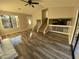 Inviting living room with wood floors, ceiling fan, and abundant natural light from a large window at 1126 Mainstreet Valley Dr, Stone Mountain, GA 30088