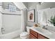 Bathroom with shower-tub combination, tiled walls, and white vanity at 185 Elvan Ne Ave, Atlanta, GA 30317