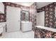 Bathroom with floral wallpaper, white vanity, and shower/tub combo at 3964 Preston Ne Ct, Brookhaven, GA 30319