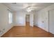 Spacious bedroom with hardwood floors, ceiling fan, and access to other rooms at 3964 Preston Ne Ct, Brookhaven, GA 30319