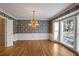 Formal dining room with floral wallpaper, hardwood floors and a chandelier at 3964 Preston Ne Ct, Brookhaven, GA 30319