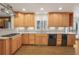 Kitchen boasts light wood cabinets, granite countertops, and stainless steel appliances at 3964 Preston Ne Ct, Brookhaven, GA 30319
