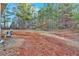 Large backyard with a shed and wooded area at 761 Woodwind Dr, Rockmart, GA 30153
