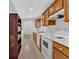 View of kitchen with wood cabinets and white appliances at 761 Woodwind Dr, Rockmart, GA 30153