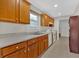 Galley kitchen with wood cabinets and white countertops at 761 Woodwind Dr, Rockmart, GA 30153