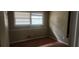 Cozy bedroom featuring a large bright window and hardwood floors at 126 Meadow Park Sw Ln, Atlanta, GA 30315