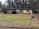 Brick ranch house with a large front yard and mature trees at 126 Meadow Park Sw Ln, Atlanta, GA 30315