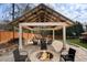 Large backyard patio with firepit and covered seating area at 2181 Ivey Creek Way, Stone Mountain, GA 30087