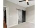 Bedroom with barn door to bathroom and carpet flooring at 2329 Mason Dr # D24, Atlanta, GA 30316