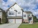 Charming two-story home with a manicured lawn and a two-car garage is perfect for Gathering living at 300 Downing Creek Trl, Canton, GA 30114