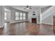 Bright living room featuring fireplace, hardwood floors, and plenty of natural light at 300 Downing Creek Trl, Canton, GA 30114