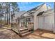 Home's exterior with deck and wooded backyard at 849 Hillandale Ln, Lithonia, GA 30058