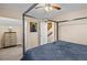 Bright bedroom with a large bed, ceiling fan, and access to upper level at 849 Hillandale Ln, Lithonia, GA 30058