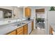 Galley kitchen with light wood cabinets, stainless steel appliances, and granite countertops at 849 Hillandale Ln, Lithonia, GA 30058