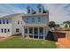 Spacious backyard with a screened-in porch, ideal for relaxing and enjoying the outdoors and neighboring house at 107 Winsome Way, Woodstock, GA 30188