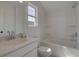 Well-lit bathroom with a single sink vanity, framed mirror, and tub with shower at 107 Winsome Way, Woodstock, GA 30188