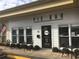 Charming exterior of Pie Bar with black tables and chairs and an American flag at 107 Winsome Way, Woodstock, GA 30188