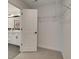 Walk-in closet with wire shelving, carpet flooring, and a view of the bathroom at 107 Winsome Way, Woodstock, GA 30188