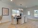 Dining room with large windows, stylish lighting fixture, and seating for six at 107 Winsome Way, Woodstock, GA 30188