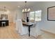 Dining room with natural light, stylish lighting fixture, and seating for six at 107 Winsome Way, Woodstock, GA 30188