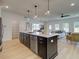 Open kitchen layout with a large island, stainless steel appliances, and seamless flow to the living area at 107 Winsome Way, Woodstock, GA 30188