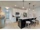 Modern kitchen featuring a large island with seating, stainless steel appliances, and stylish pendant lighting at 107 Winsome Way, Woodstock, GA 30188