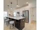 Bright kitchen features a large island, stainless steel appliances, and modern pendant lighting at 107 Winsome Way, Woodstock, GA 30188
