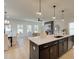 Modern kitchen with a large island, quartz countertops, and stainless steel appliances at 107 Winsome Way, Woodstock, GA 30188