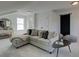 Cozy living room showcasing a sectional sofa, accent table, and natural lighting at 107 Winsome Way, Woodstock, GA 30188