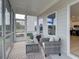 Relaxing screened porch with outdoor seating and view of the surrounding landscape at 107 Winsome Way, Woodstock, GA 30188