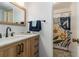 Stylish bathroom featuring modern vanity with wood cabinets, marble countertop, and patterned shower curtain at 320 Tuxworth Cir, Decatur, GA 30033