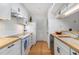 Galley kitchen with butcher block countertops, white cabinets and stainless appliances at 320 Tuxworth Cir, Decatur, GA 30033