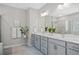 Elegant bathroom featuring a double sink vanity, framed mirror, and a glass-enclosed shower at 3335 Park Pointe Cir, Scottdale, GA 30079