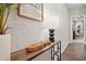 Stylish entryway table with decor in a hallway with hardwood floors, leading to an open-concept living space at 3335 Park Pointe Cir, Scottdale, GA 30079