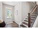 Inviting entryway with staircase, hardwood floors, and natural light streaming through a glass-paneled front door at 3335 Park Pointe Cir, Scottdale, GA 30079