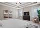 Bright main bedroom with tray ceiling, plush carpeting, and a comfortable seating area in a neutral color palette at 3335 Park Pointe Cir, Scottdale, GA 30079