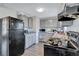 Galley kitchen with black appliances and granite countertops at 4646 Biffle Rd, Stone Mountain, GA 30088