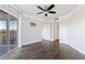 Bright bedroom featuring hardwood floors, ceiling fan and sliding glass doors leading to a balcony at 1 Biscayne Nw Dr # 809, Atlanta, GA 30309